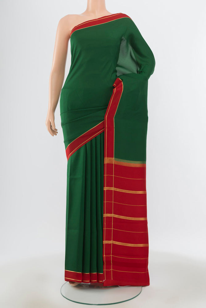 Pure Silk Pure Zari Bottle Green Mysore Crepe Saree with Zari Butta on the body and Silk Border.  displayed on a mannequin