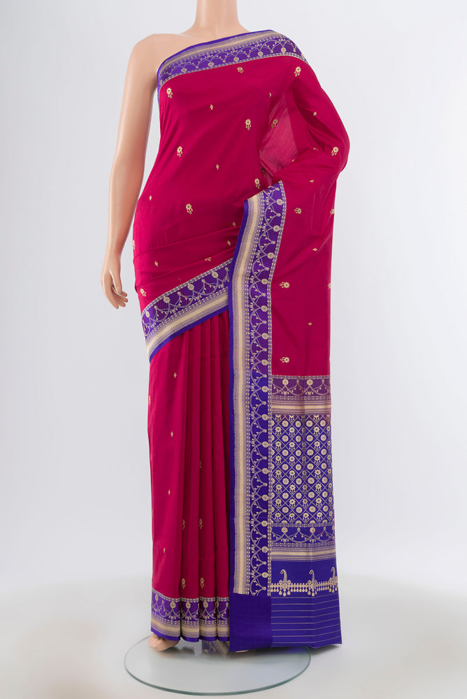 Maroon Banarasi Katan Silk Saree with Zari Butta on the body and Silk Border.  displayed on a mannequin