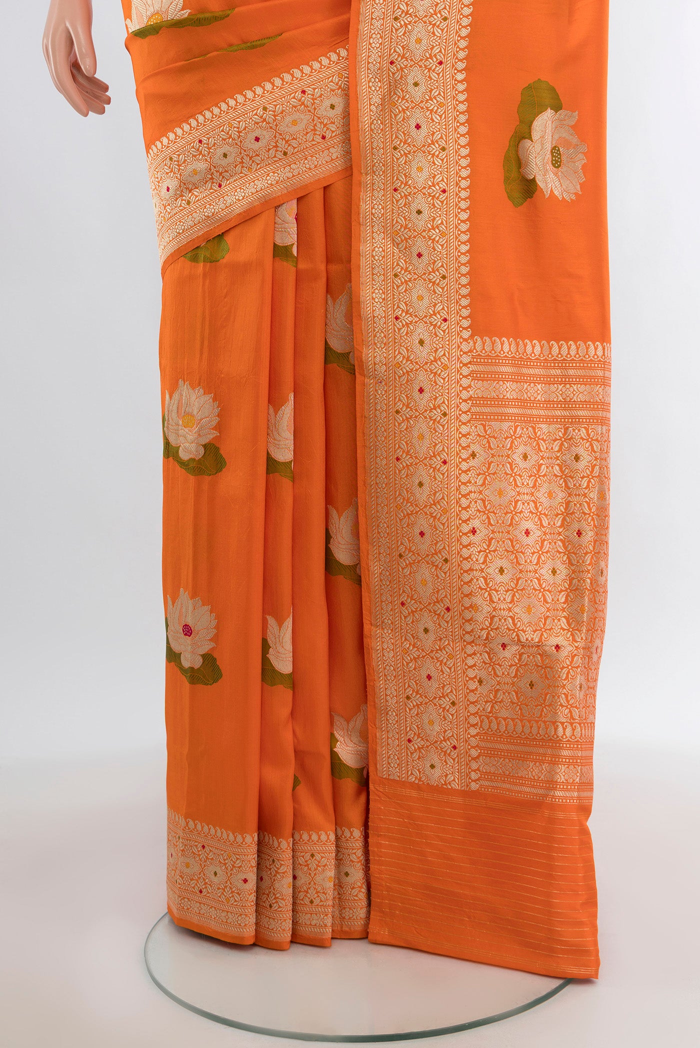 Pleats and pallu of Orange Banarasi Silk Saree with Zari And Thread Butta on the body and Zari Border. 