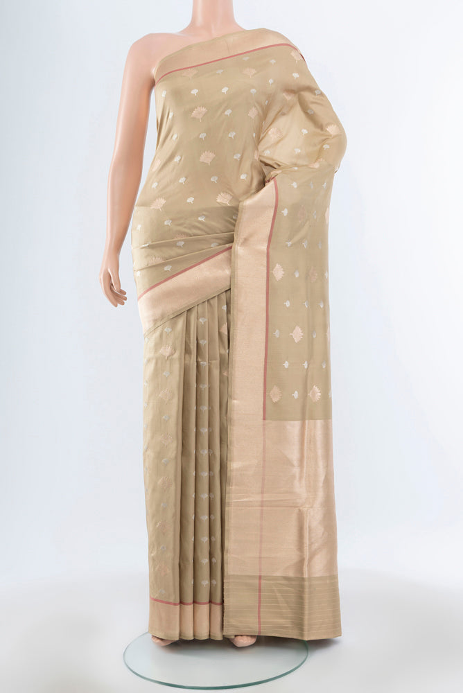 Beige Banarasi Katan Silk Saree with Zari Butta on the body and Silk Border.  displayed on a mannequin