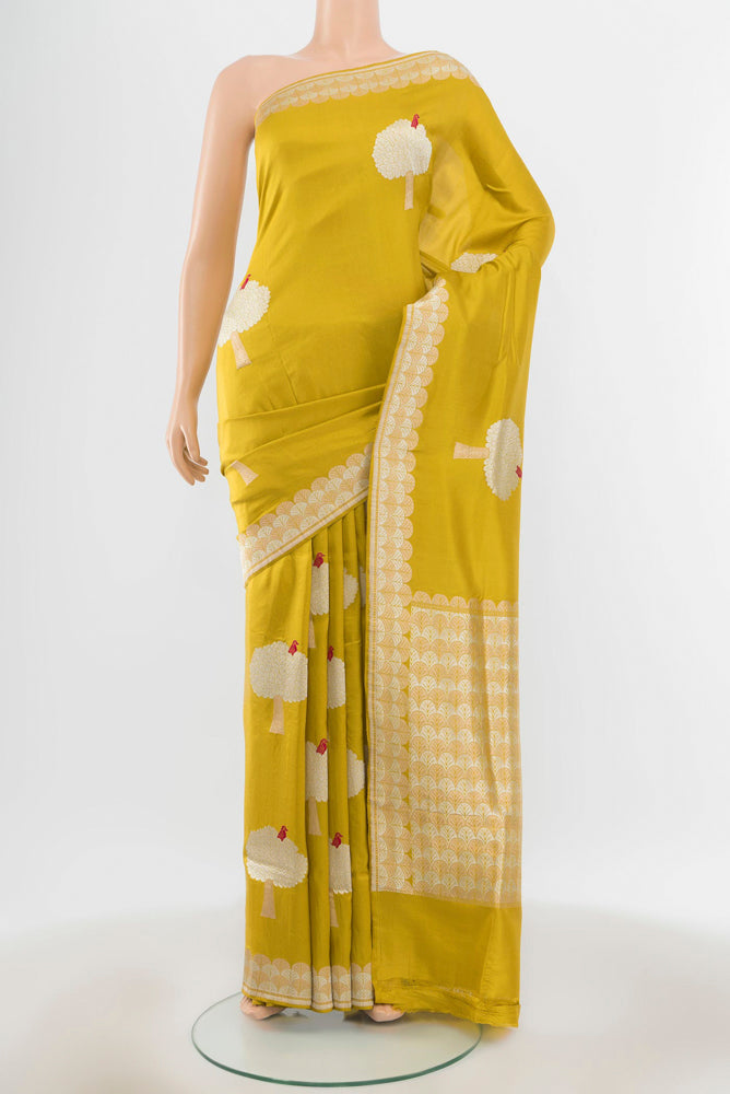 Pure Silk Pure Zari Light Green Banarasi Katan Saree with Zari Butta on the body and Silk Border.  displayed on a mannequin