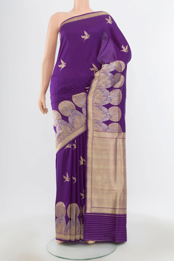 Pure Silk Pure Zari Violet Banarasi Katan Saree with Zari Butta on the body and Silk Border.  displayed on a mannequin