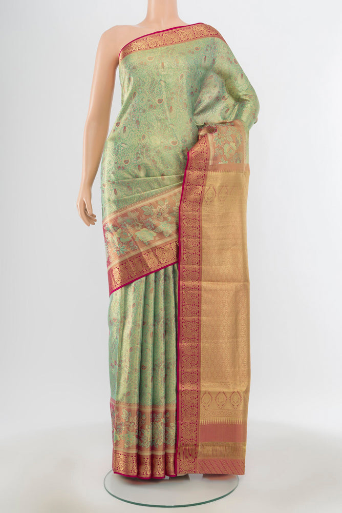 Pure Silk Pure Zari Pista Green Kanchipuram Saree with Zari Butta on the body and Silk Border.  displayed on a mannequin