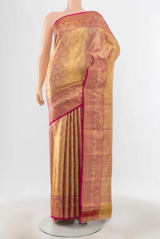 Golden Peach Kanchipuram Silk Saree with Zari Brocade on the body and Silk Border.  displayed on a mannequin