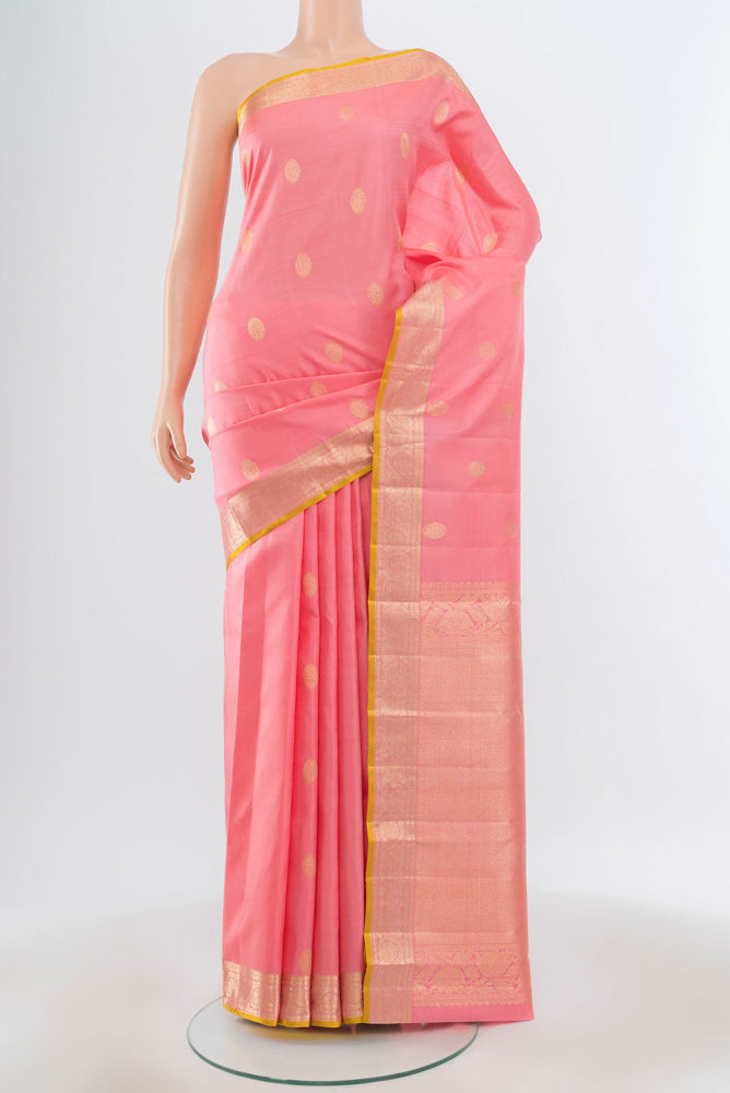 Pure Silk Pure Zari Rose Gold Kanjivaram Saree with Zari Butta on the body and Silk Border.  displayed on a mannequin