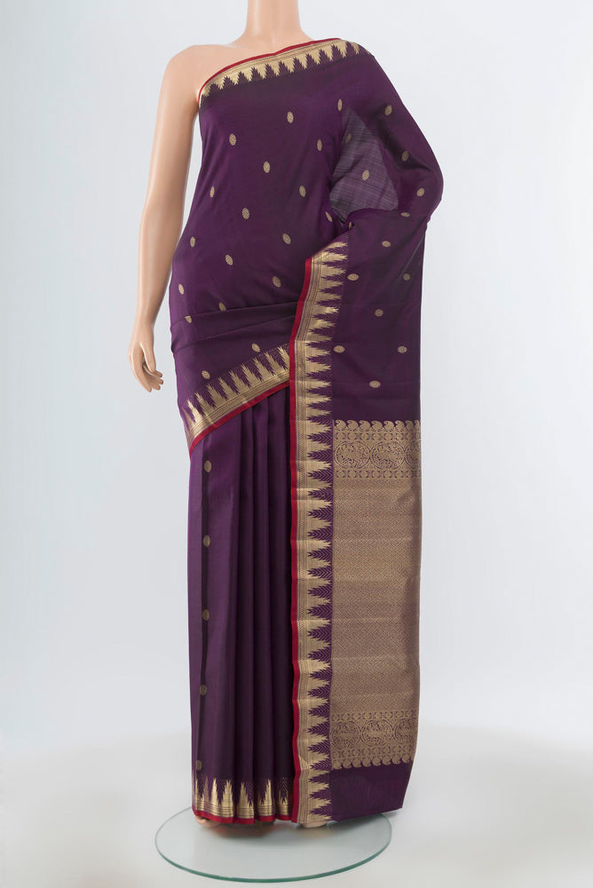 Pure Silk Pure Zari Violet Kanjivaram Saree with Zari Butta on the body and Silk Border.  displayed on a mannequin