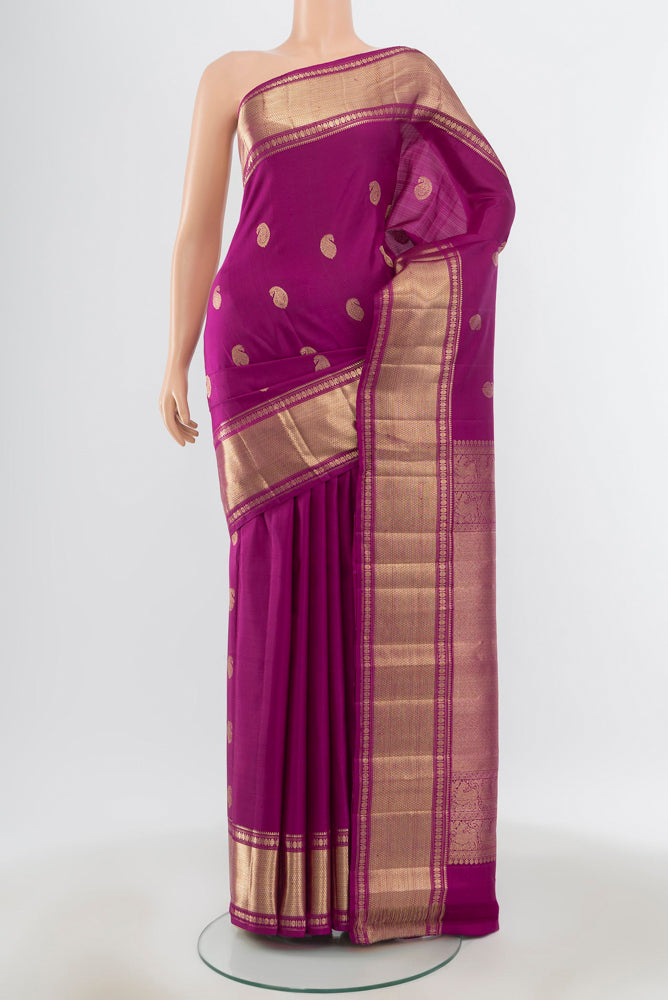 Pure Silk Pure Zari Purple Kanjivaram Saree with Zari Butta on the body and Silk Border.  displayed on a mannequin