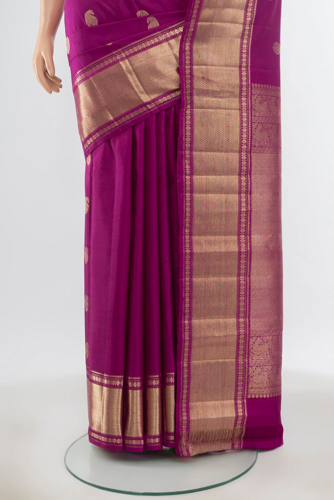 Pleats and pallu of Pure Silk Pure Zari Purple Kanjivaram Saree with Zari Butta on the body and Silk Border. 