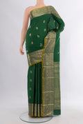 Pure Silk Bottle Green Kanjivaram Saree with Zari Butta on the body and Zari Border.  displayed on a mannequin
