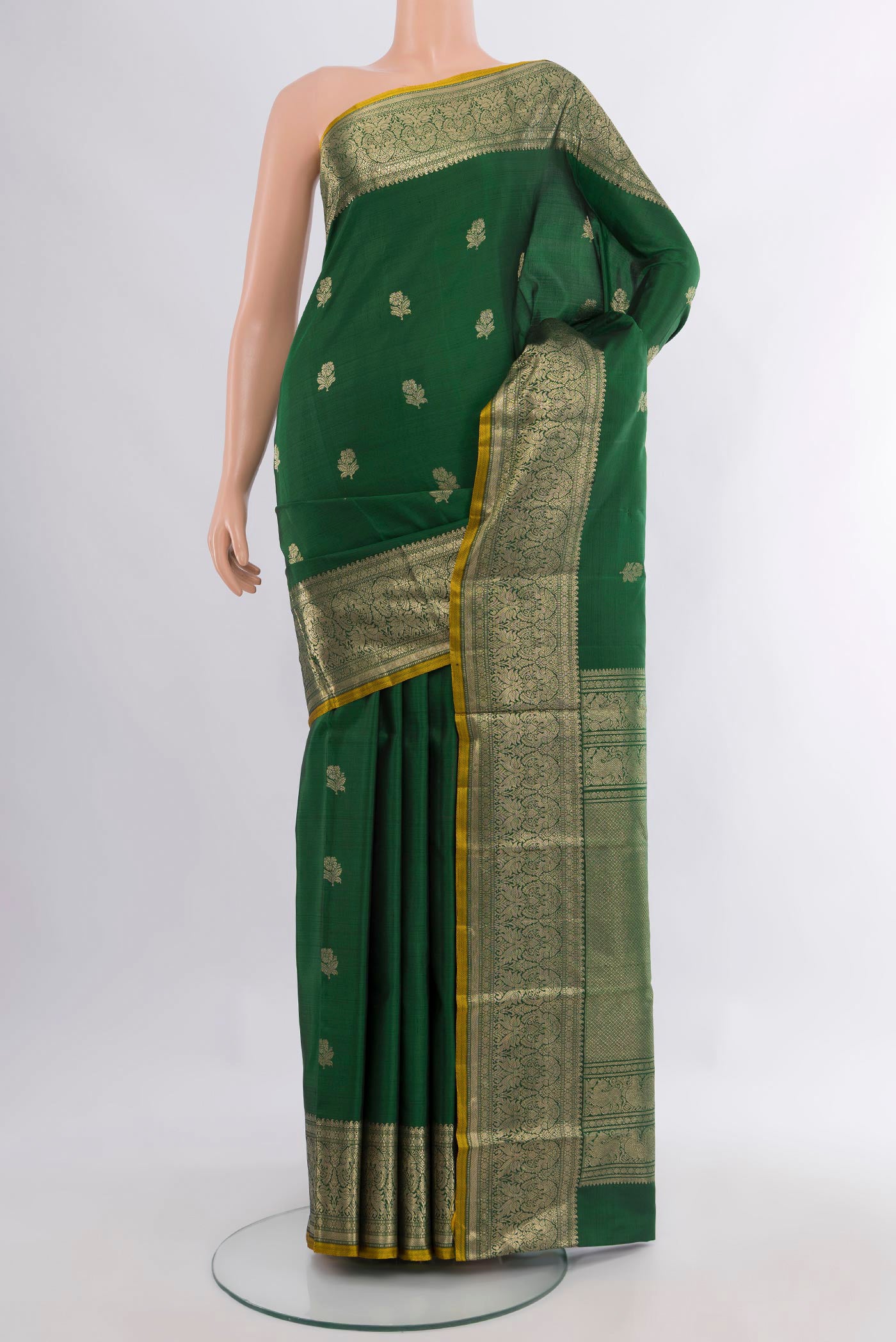 Pure Silk Bottle Green Kanjivaram Saree with Zari Butta on the body and Zari Border.  displayed on a mannequin