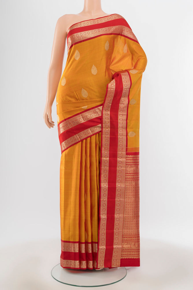 Pure Silk Pure Zari Yellow Kanjivaram Saree with Zari Butta on the body and Silk Border.  displayed on a mannequin