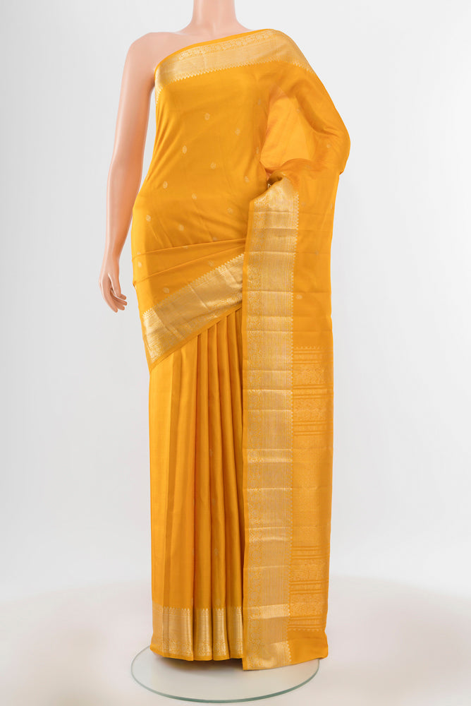 Pure Silk Pure Zari Yellow Kanjivaram Saree with Zari Butta on the body and Silk Border.  displayed on a mannequin