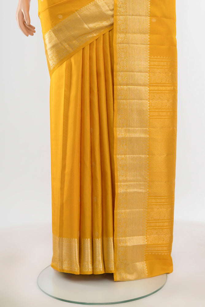 Pleats and pallu of Pure Silk Pure Zari Yellow Kanjivaram Saree with Zari Butta on the body and Silk Border. 