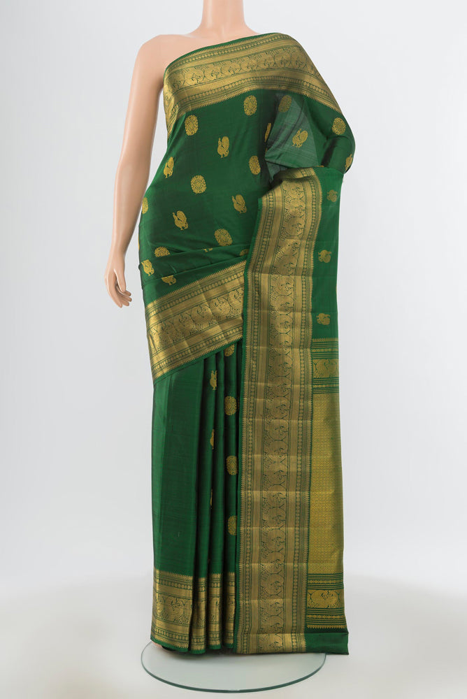 Pure Silk Pure Zari Bottle Green Kanjivaram Saree with Zari Butta on the body and Silk Border.  displayed on a mannequin