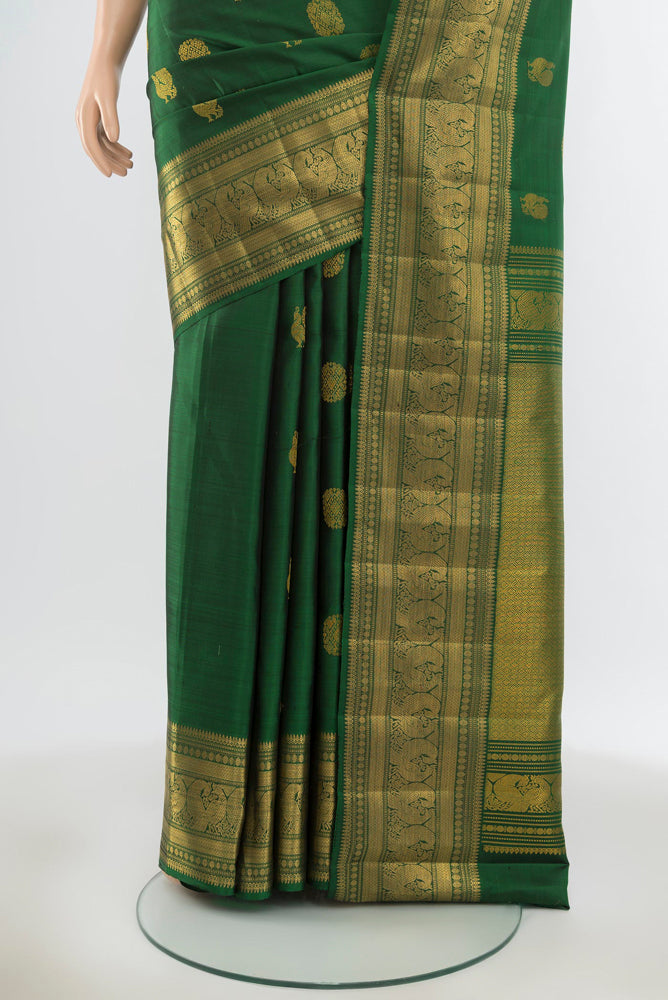 Pleats and pallu of Pure Silk Pure Zari Bottle Green Kanjivaram Saree with Zari Butta on the body and Silk Border. 