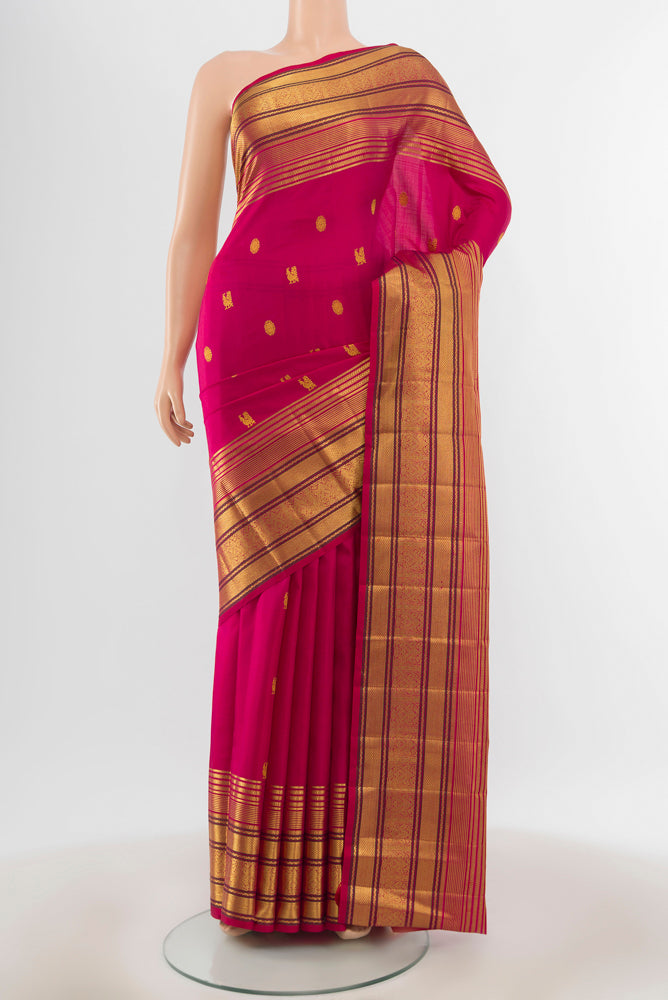 Pure Silk Pure Zari Dark Pink Kanjivaram Saree with Zari Butta on the body and Silk Border.  displayed on a mannequin