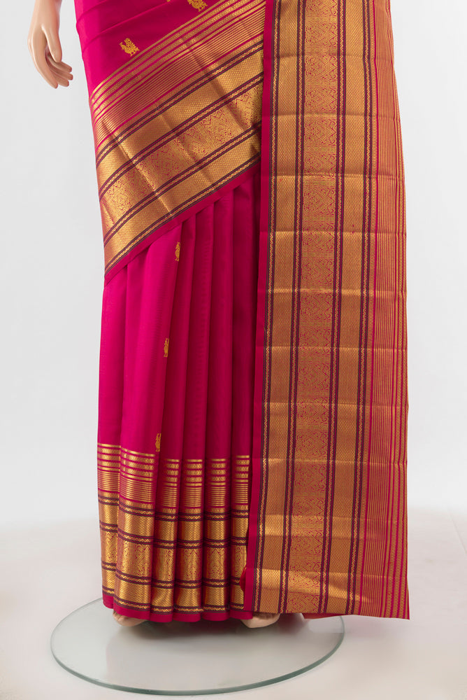 Pleats and pallu of Pure Silk Pure Zari Dark Pink Kanjivaram Saree with Zari Butta on the body and Silk Border. 
