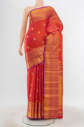 Pure Silk Pure Zari Peach Kanjivaram Saree with Zari Butta on the body and Silk Border.  displayed on a mannequin