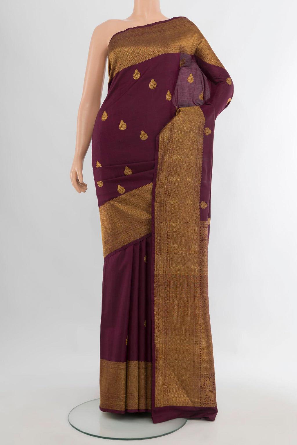 Pure Silk Coffee Brown Kanchipuram Saree with Zari Butta on the body and Zari Border.  displayed on a mannequin