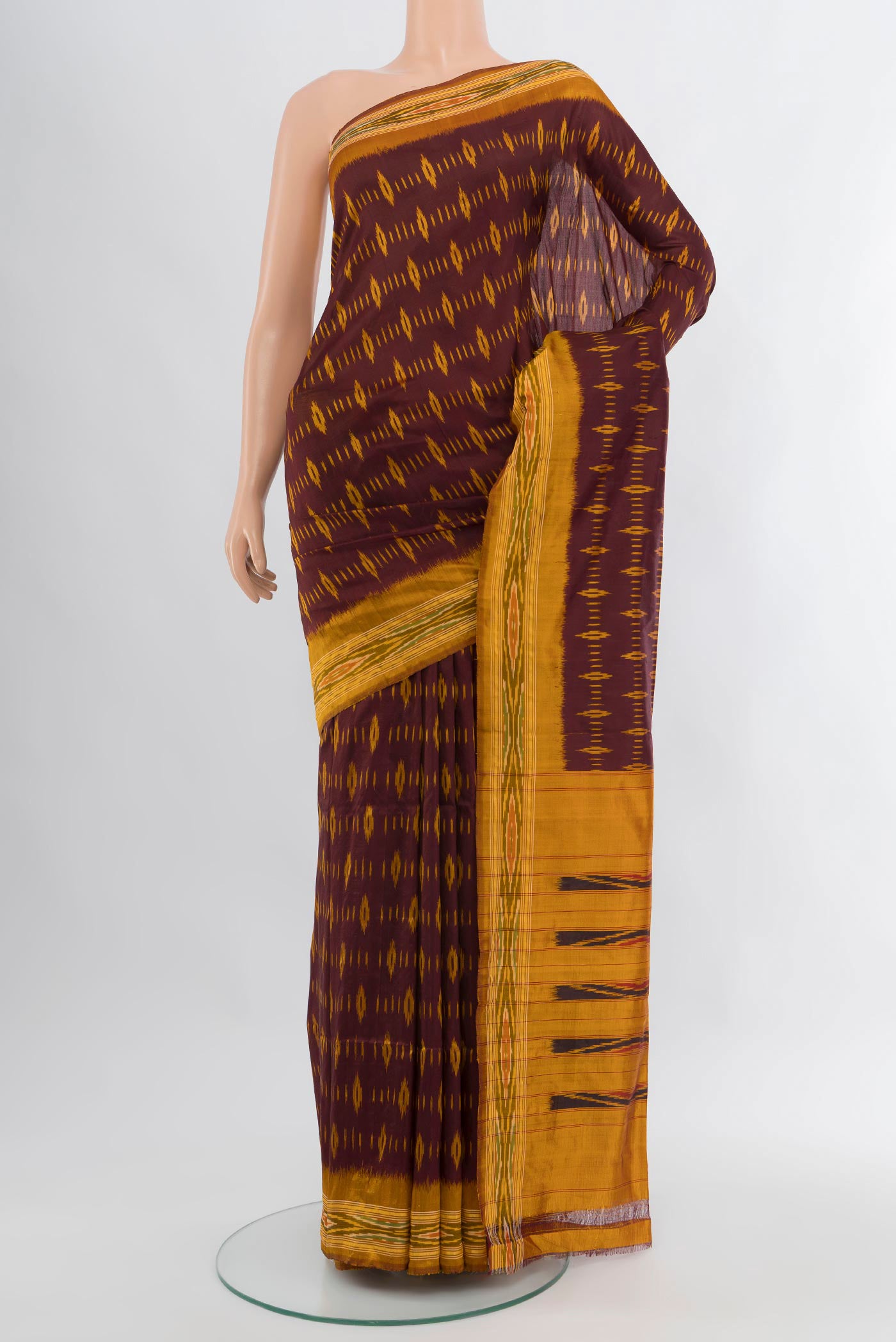 Coffee Brown Pochampally Silk Saree with Ikat design on the body and Ikat Border.  displayed on a mannequin