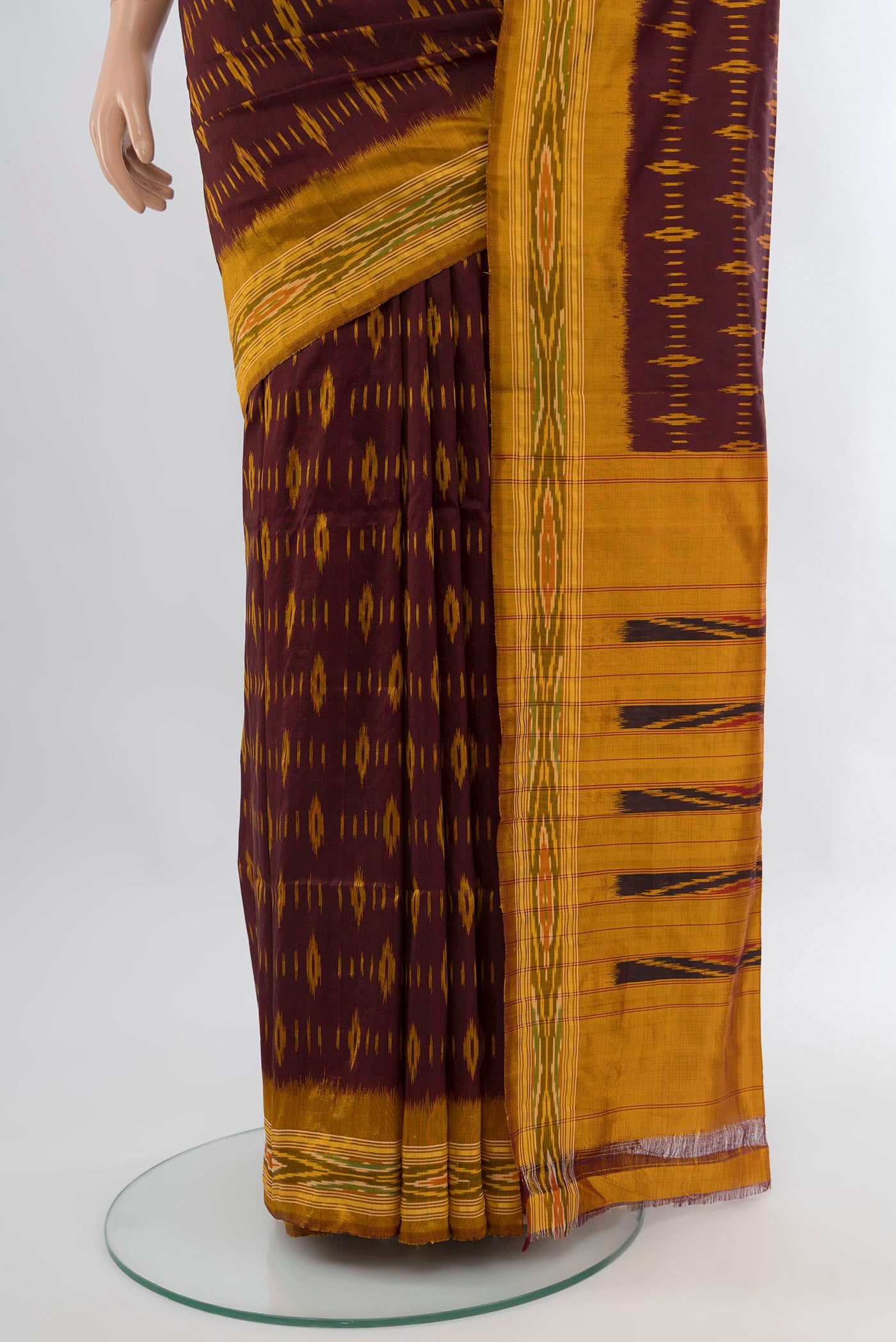 Pleats and pallu of Coffee Brown Pochampally Silk Saree with Ikat design on the body and Ikat Border. 