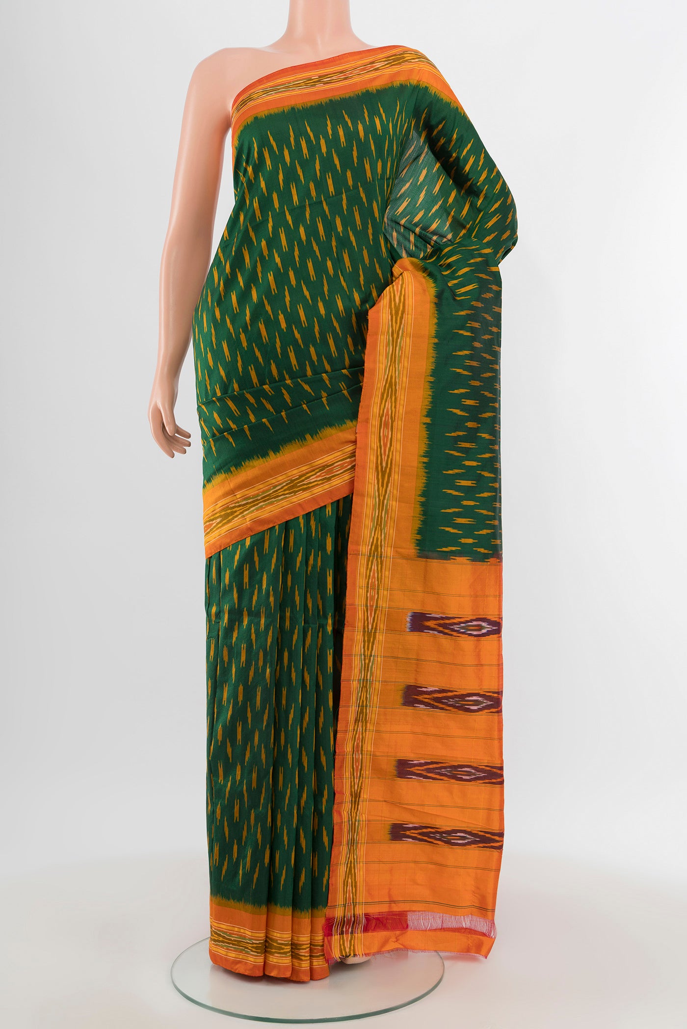 Bottle Green Pochampally Silk Saree with Ikat design on the body and Ikat Border.  displayed on a mannequin