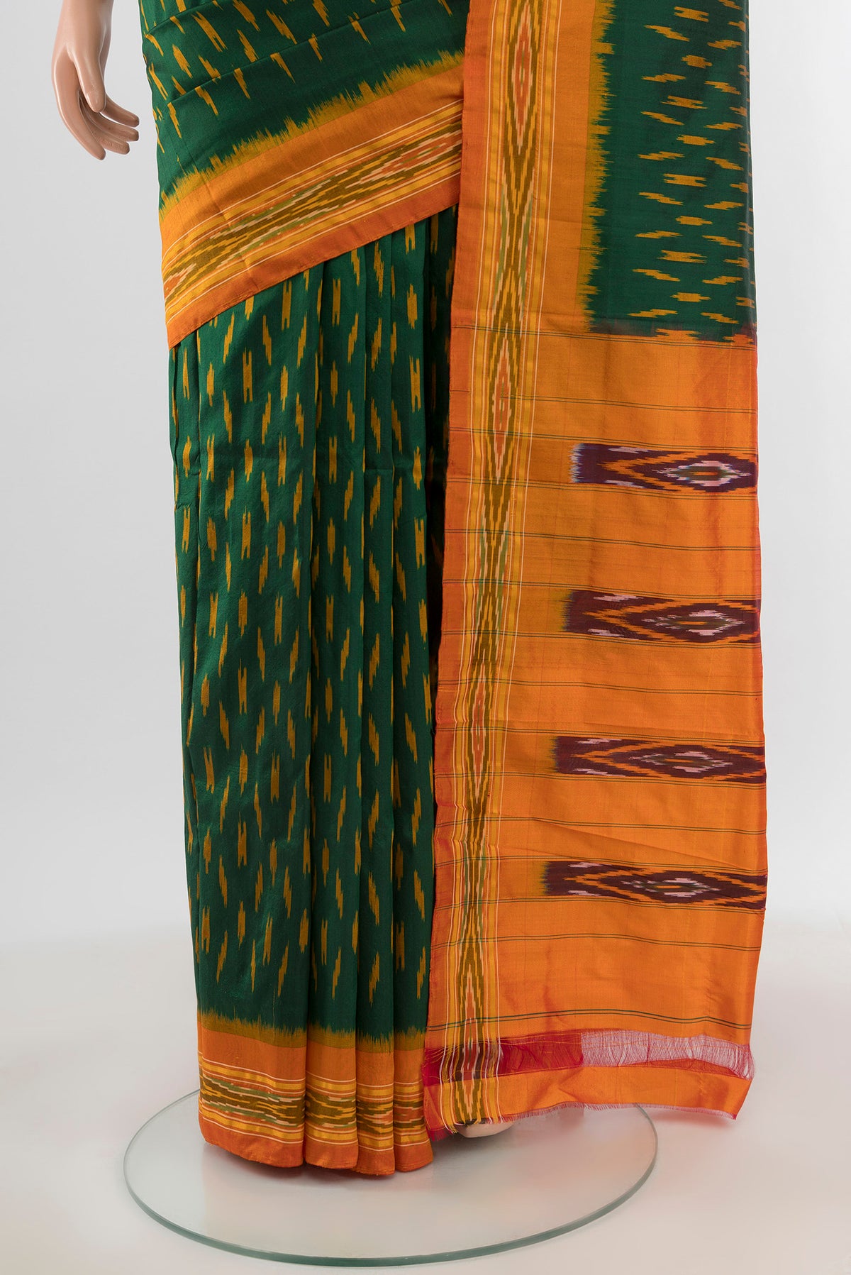 Pleats and pallu of Bottle Green Pochampally Silk Saree with Ikat design on the body and Ikat Border. 