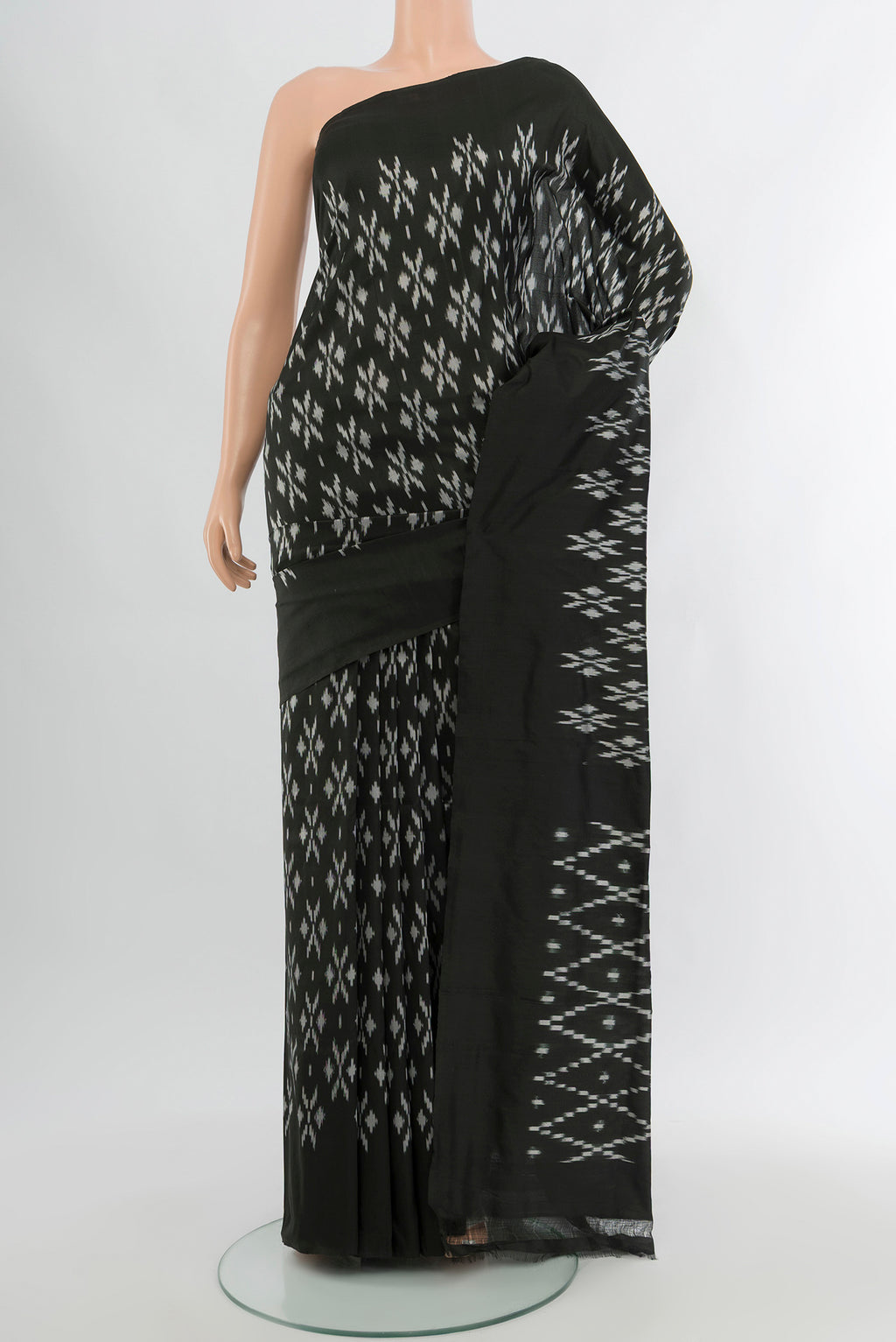 Black Pochampally Silk Saree with Pure Ikat on the body and Plain Border.  displayed on a mannequin