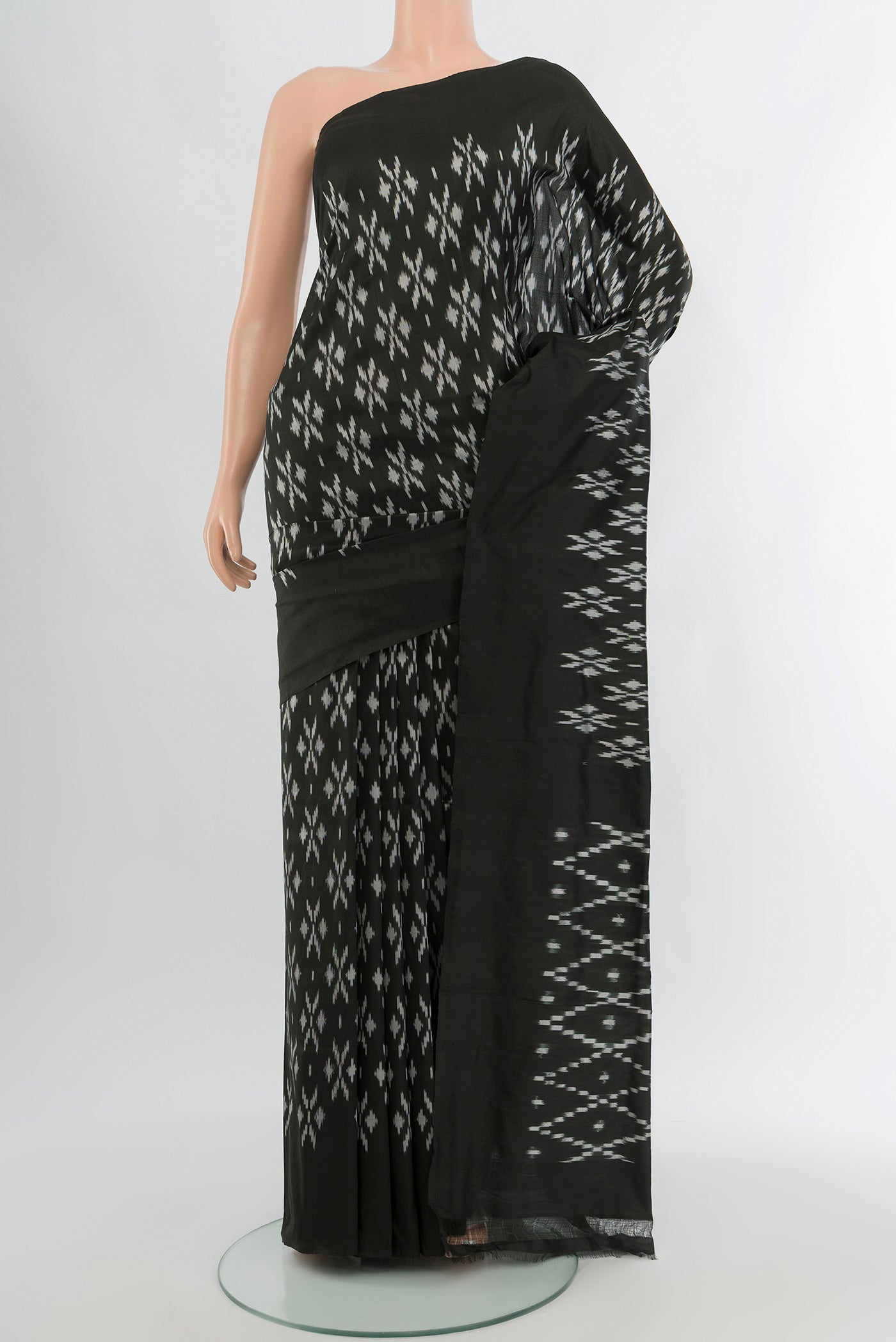 Black Pochampally Silk Saree with Pure Ikat on the body and Plain Border.  displayed on a mannequin