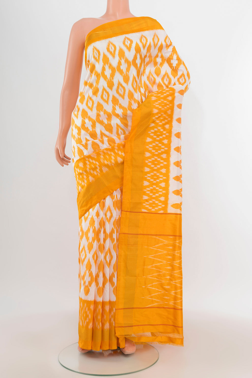 Off White Pochampally Silk Saree with Ikat design on the body and Ikat Border.  displayed on a mannequin