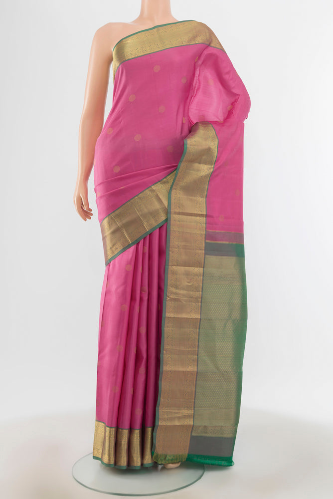 Rose pink Kanchipuram Silk Saree with Zari Butta on the body and Silk Border.  displayed on a mannequin
