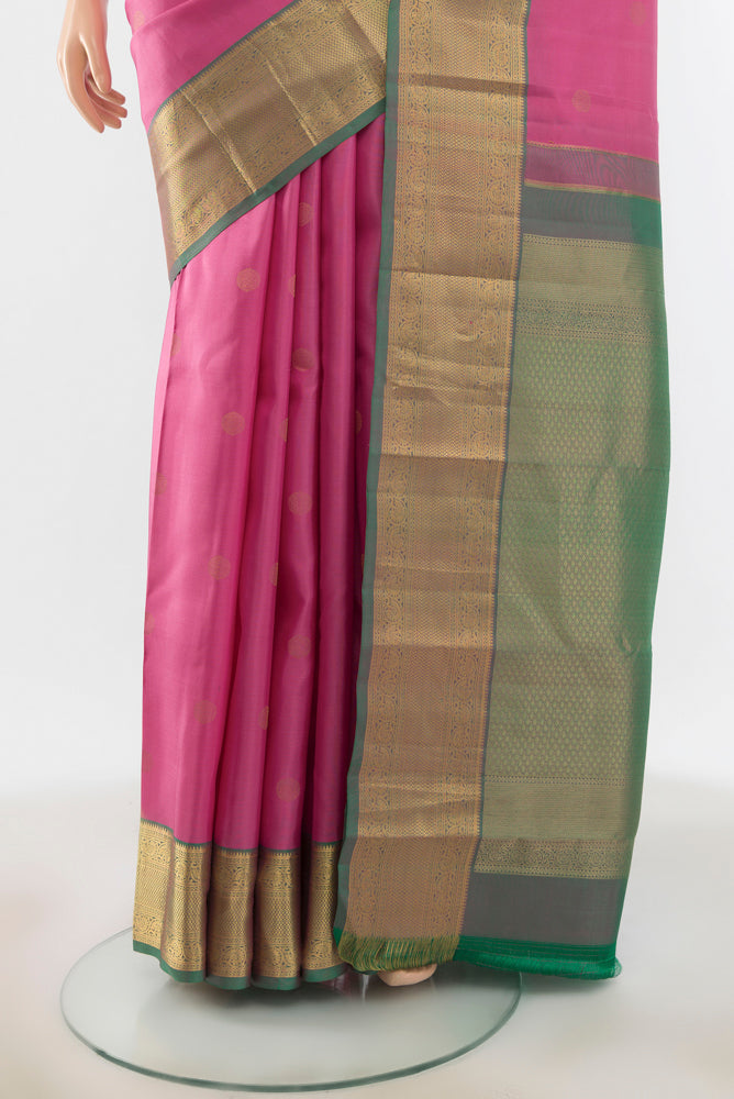 Pleats and pallu of Rose pink Kanchipuram Silk Saree with Zari Butta on the body and Silk Border. 