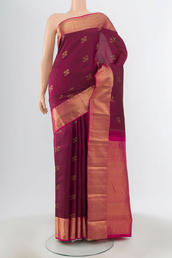 Maroon Kanjivaram Silk Saree with Zari Butta on the body and Silk Border.  displayed on a mannequin