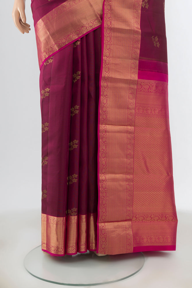 Pleats and pallu of Maroon Kanjivaram Silk Saree with Zari Butta on the body and Silk Border. 