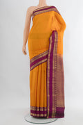 Yellow Kanchipuram Silk Saree with Checked design on the body and Zari Border.  displayed on a mannequin
