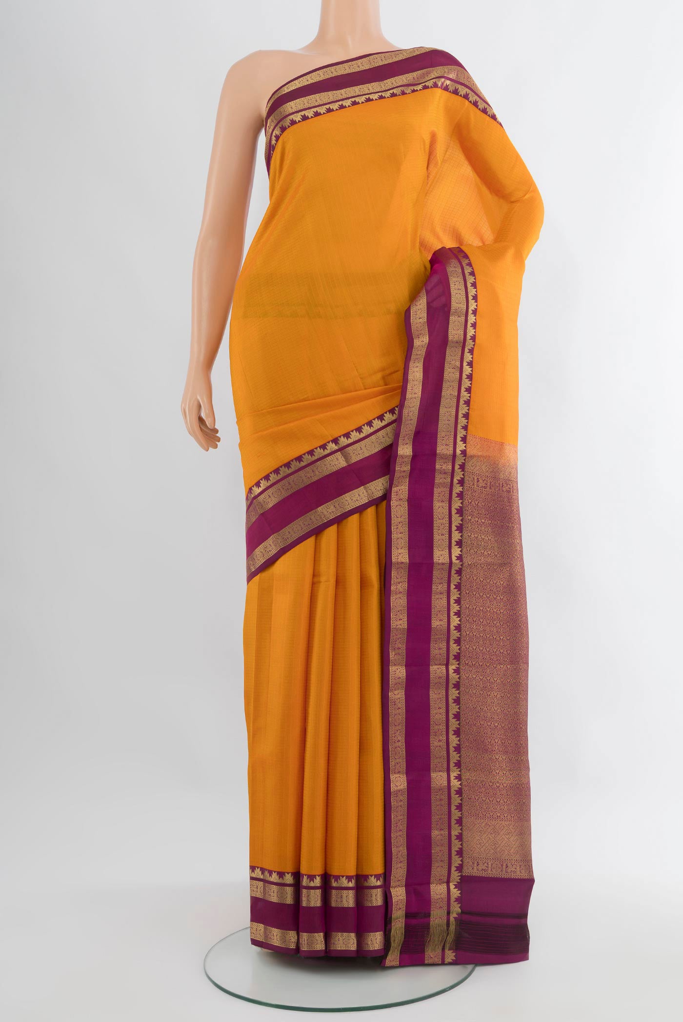 Yellow Kanchipuram Silk Saree with Checked design on the body and Zari Border.  displayed on a mannequin