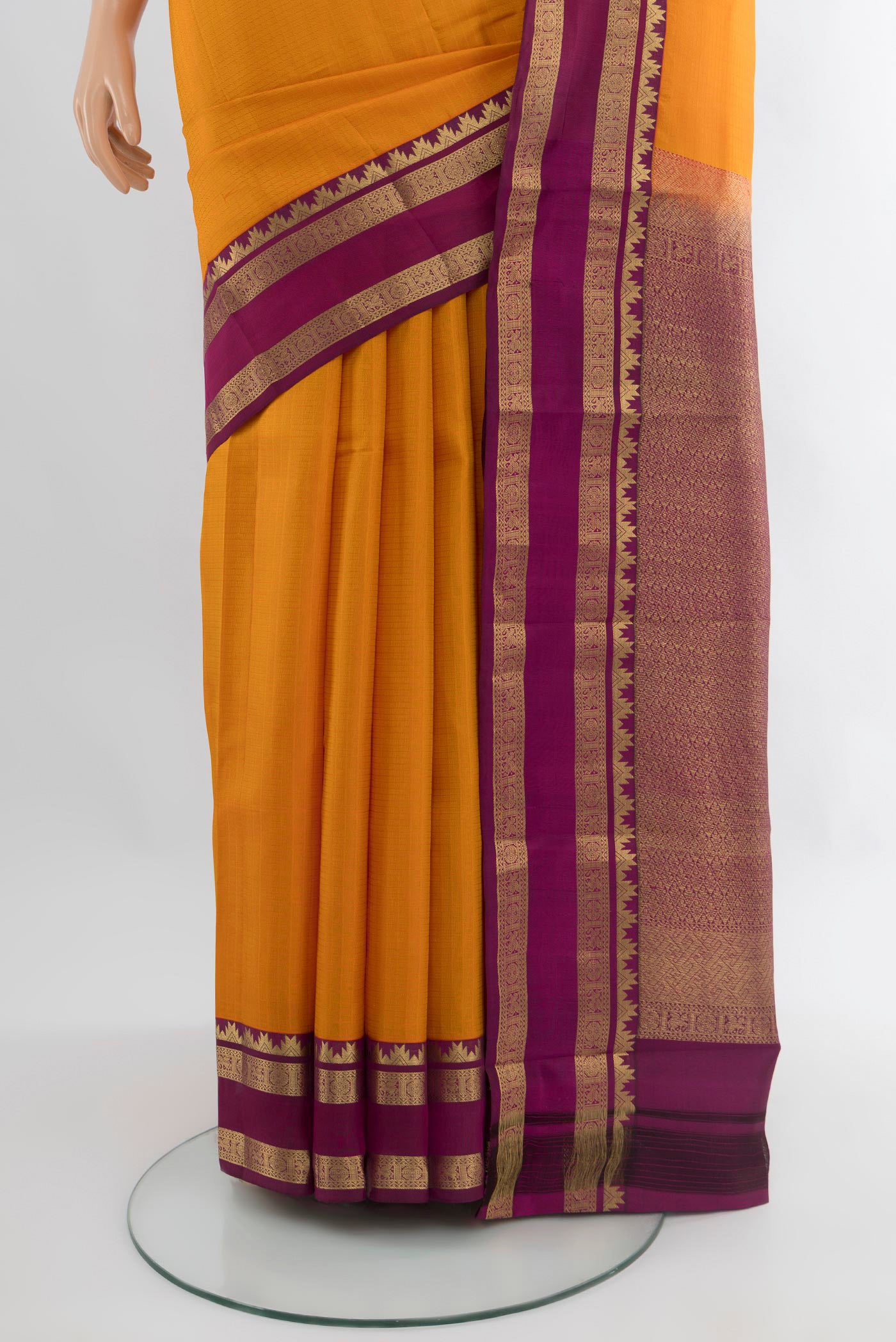 Pleats and pallu of Yellow Kanchipuram Silk Saree with Checked design on the body and Zari Border. 