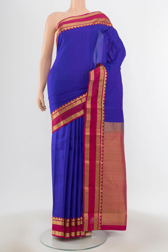 Dark Blue Kanchipuram Silk Saree with Zari Butta on the body and Silk Border.  displayed on a mannequin