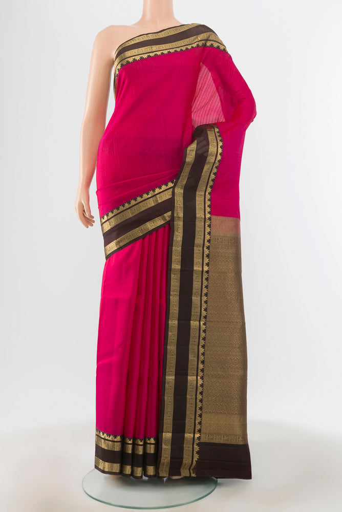 Peach Kanchipuram Silk Saree with Zari Brocade on the body and Silk Border.  displayed on a mannequin