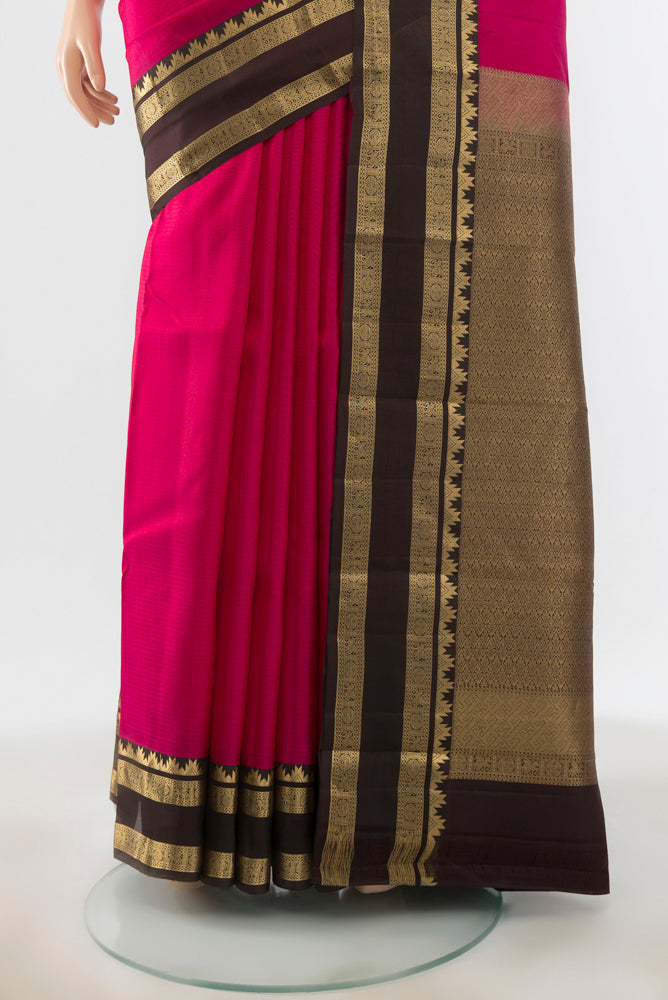 Pleats and pallu of Peach Kanchipuram Silk Saree with Zari Brocade on the body and Silk Border. 
