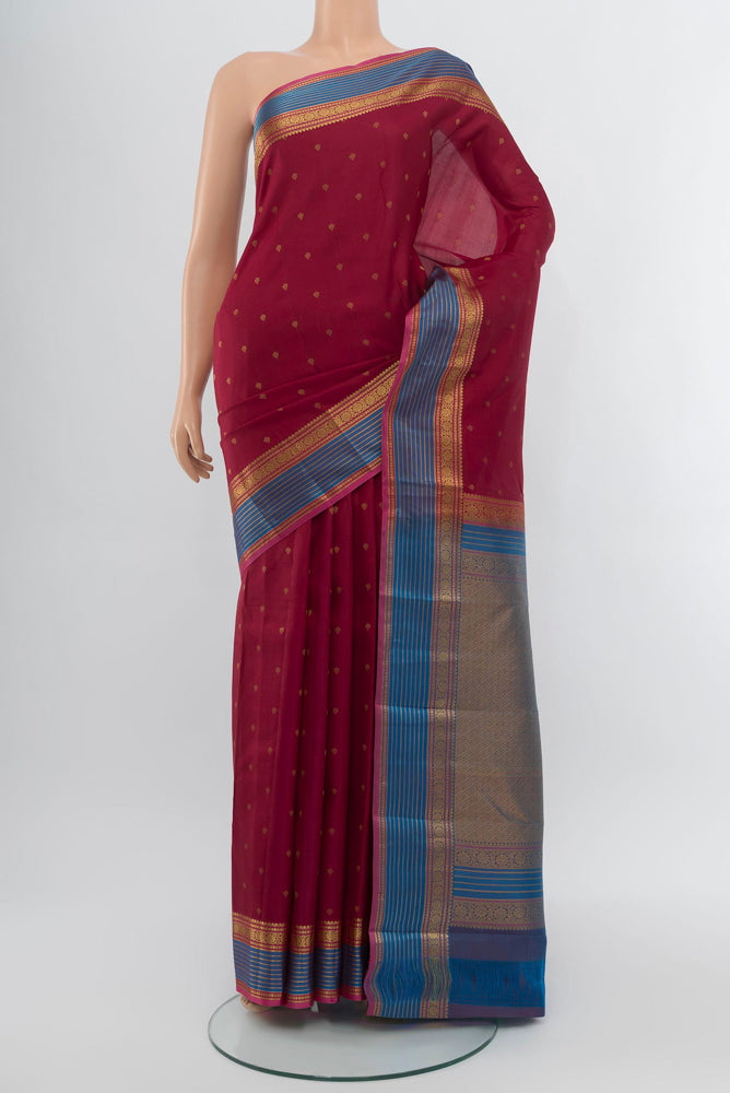 Maroon Kanchipuram Silk Saree with Zari Butta on the body and Silk Border.  displayed on a mannequin