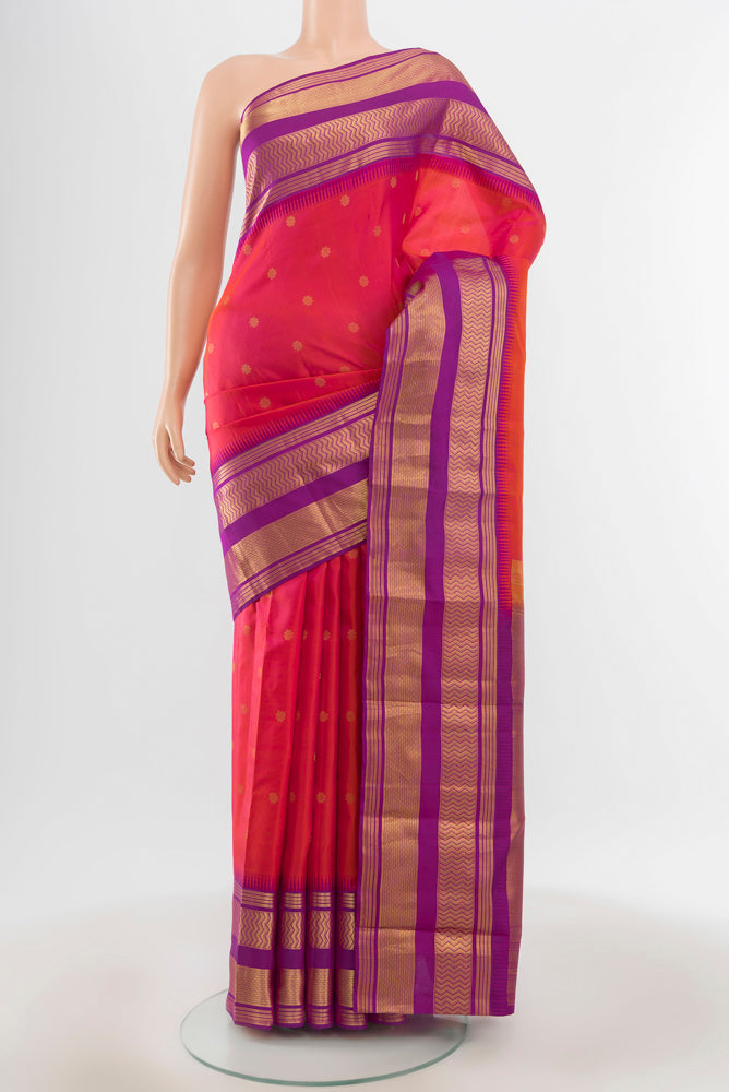 Pure Silk Pure Zari Peach Kanjivaram Saree with Zari Butta on the body and Silk Border.  displayed on a mannequin