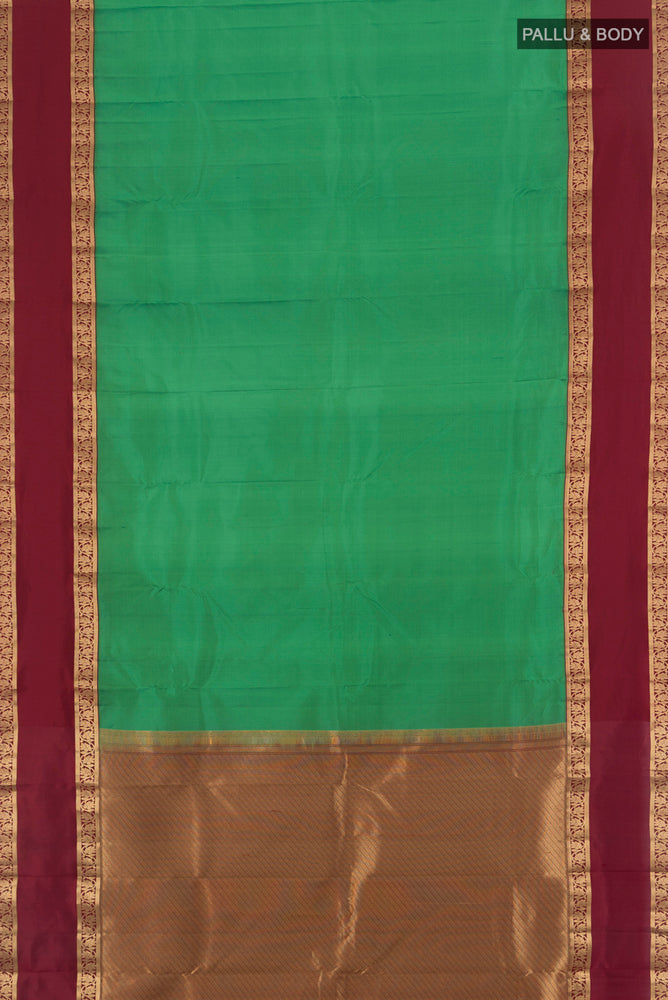 Flat view of Light Green Kanchipuram Silk Saree with Zari Butta on the body and Silk Border. 