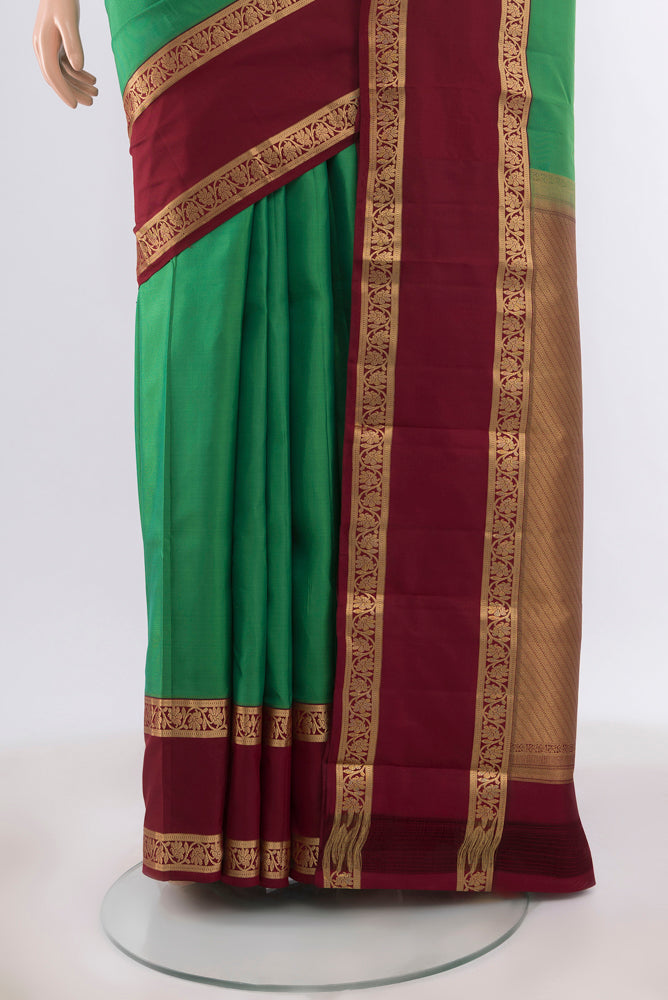 Pleats and pallu of Light Green Kanchipuram Silk Saree with Zari Butta on the body and Silk Border. 