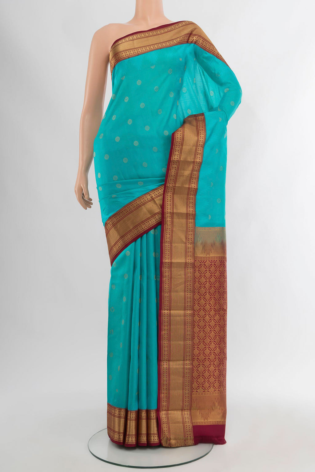 Light Blue Kanchipuram Silk Saree with Zari Butta on the body and Zari Border.  displayed on a mannequin