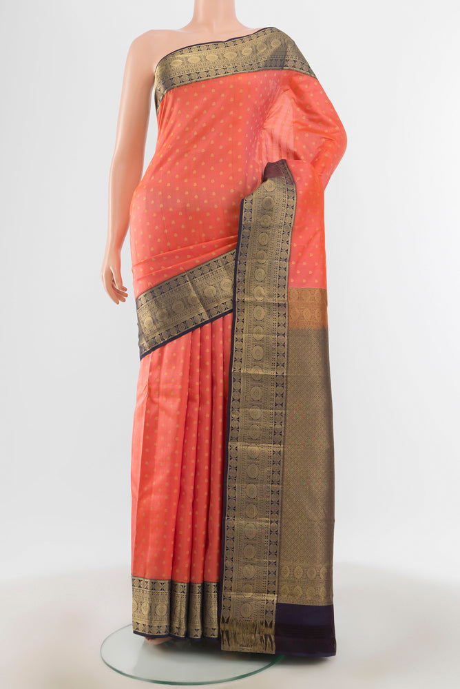 Rose Gold Kanchipuram Silk Saree with Zari Butta on the body and Silk Border.  displayed on a mannequin