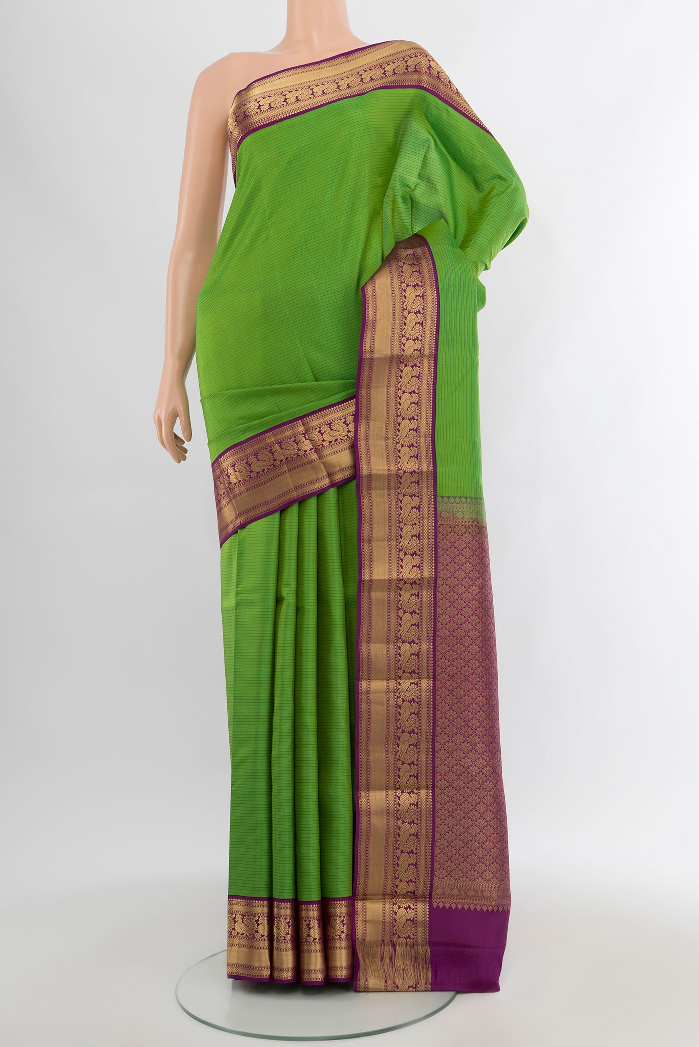 Light Green Kanchipuram Silk Saree with Stripes on the body and Zari Border.  displayed on a mannequin