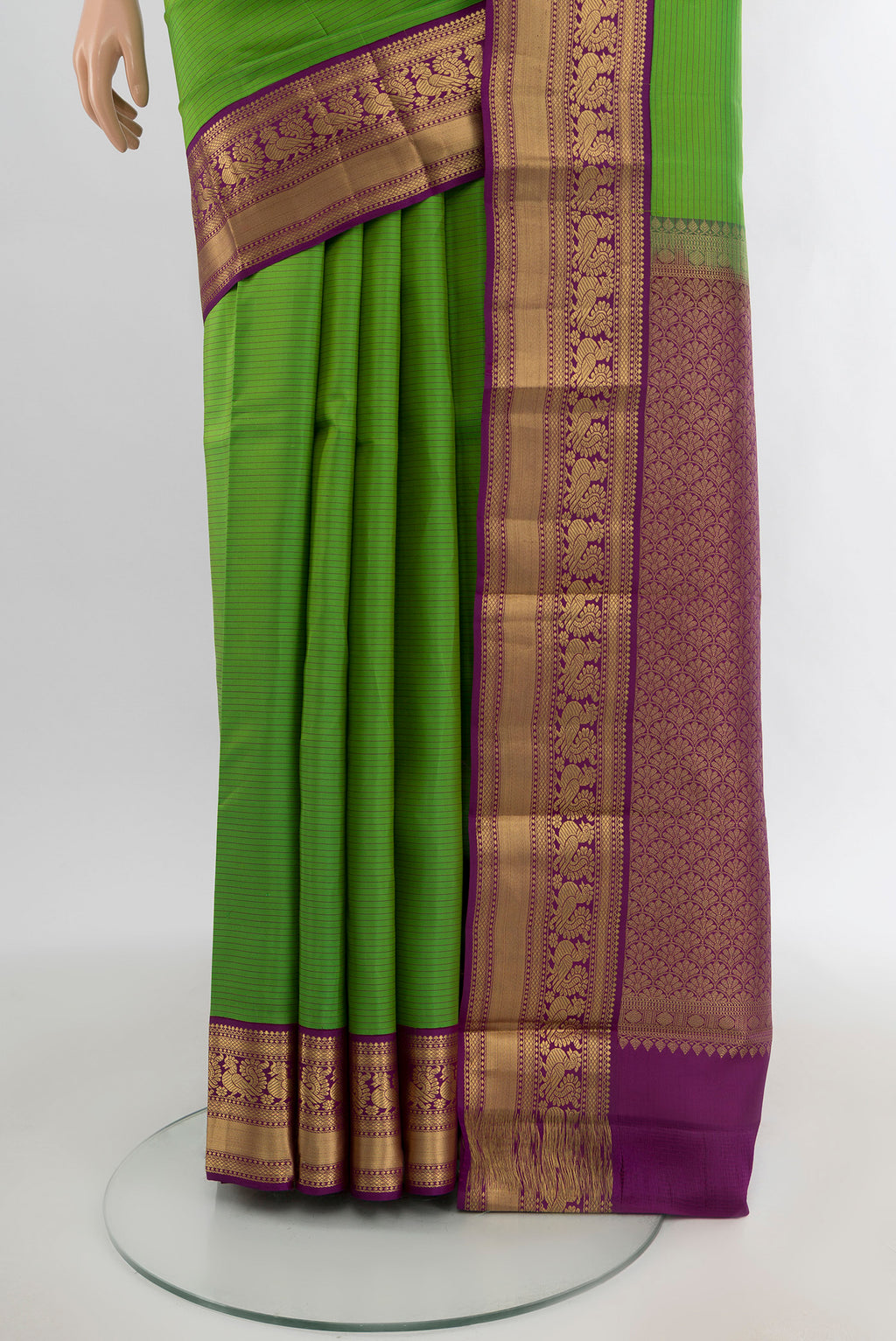 Pleats and pallu of Light Green Kanchipuram Silk Saree with Stripes on the body and Zari Border. 