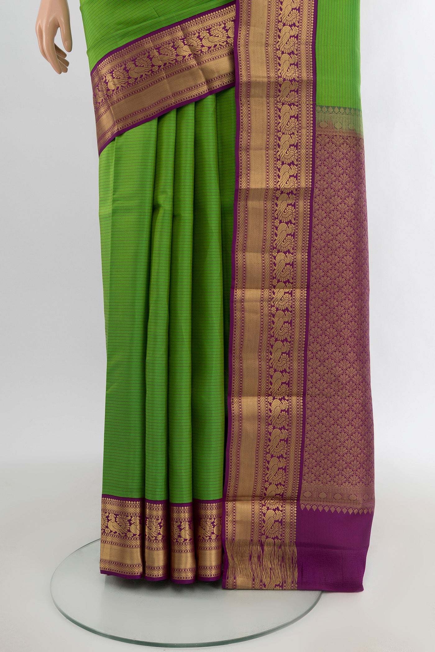Pleats and pallu of Light Green Kanchipuram Silk Saree with Stripes on the body and Zari Border. 
