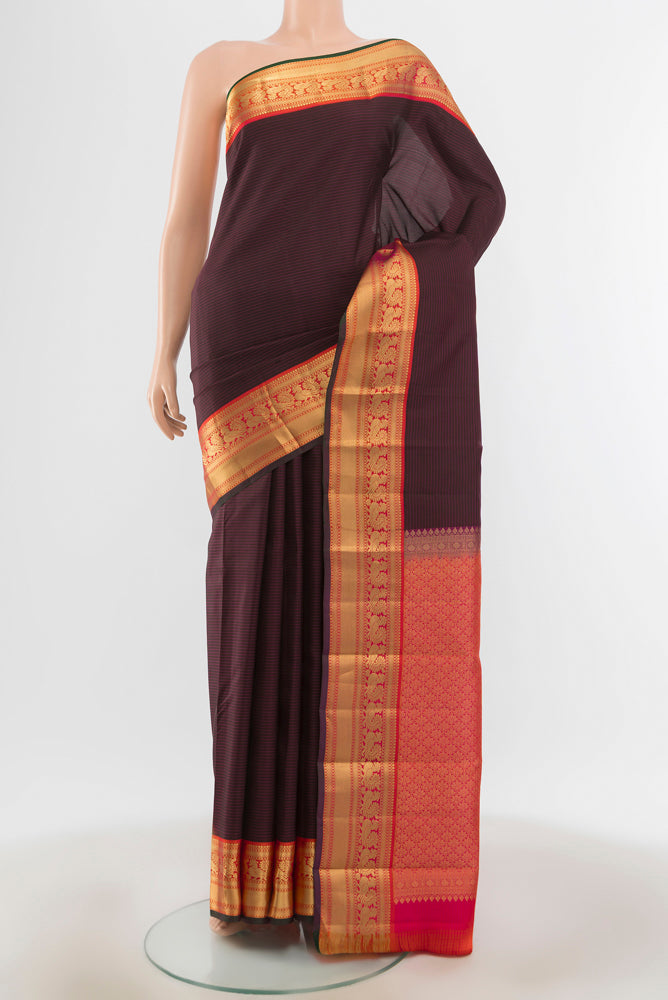 Brown Kanchipuram Silk Saree with Zari Butta on the body and Silk Border.  displayed on a mannequin